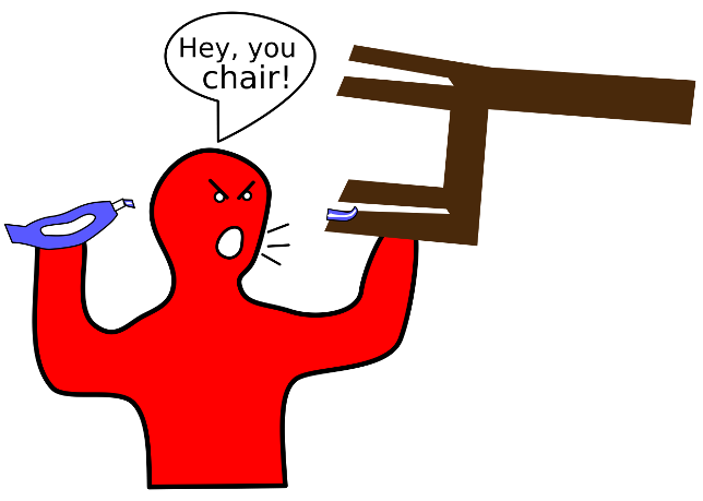 A person holds a chair in one hand with the chair legs facing him and container of toothpaste in the other. Some toothpaste is on one of the chair legs. He looks mad and is shouting at the chair.
